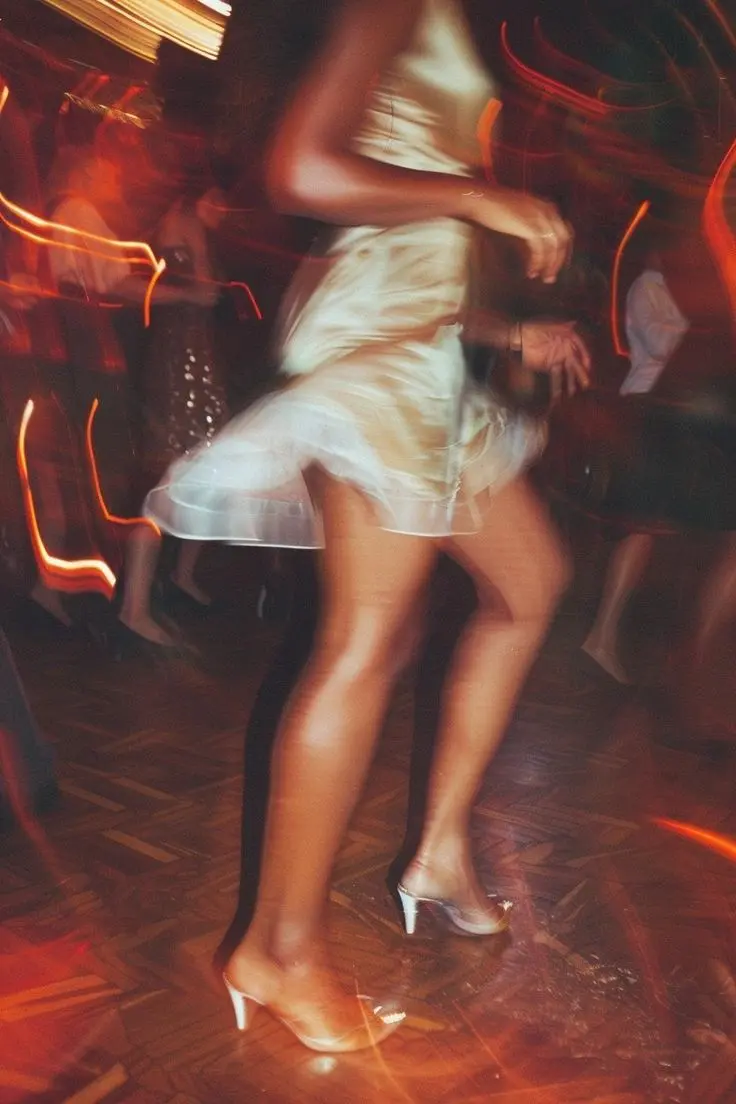 A guest dancing in warm, blurred light