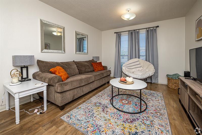 Furnished one-bedroom living room with a sofa and round coffee table