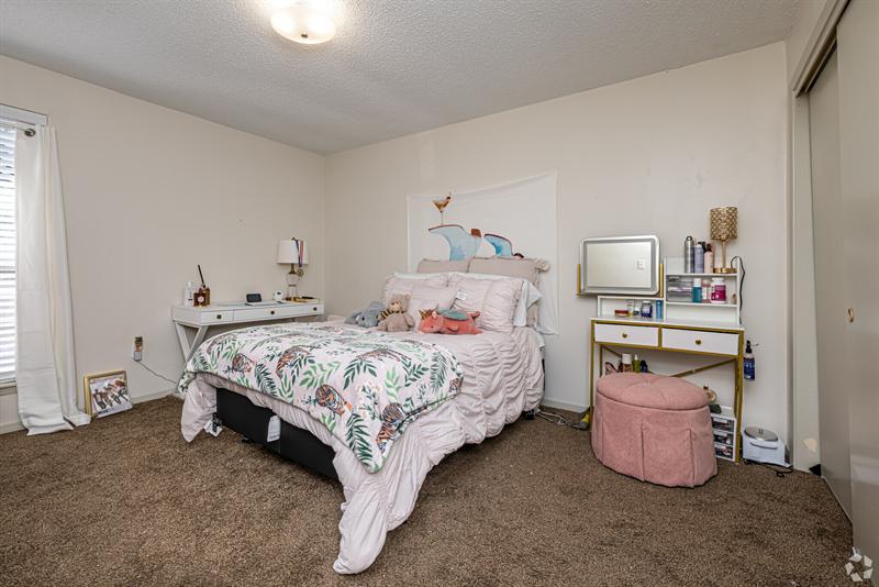 Furnished primary bedroom in a two-bedroom apartment