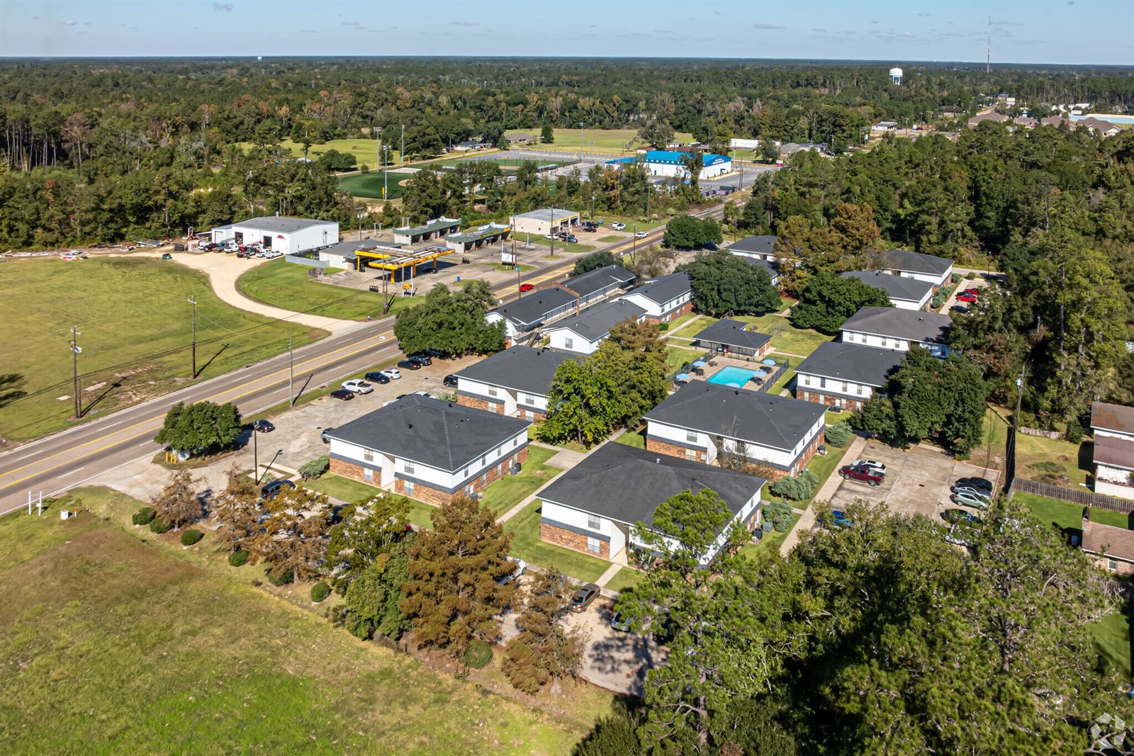 Aerial view of College Town Apartments surrounded by trees