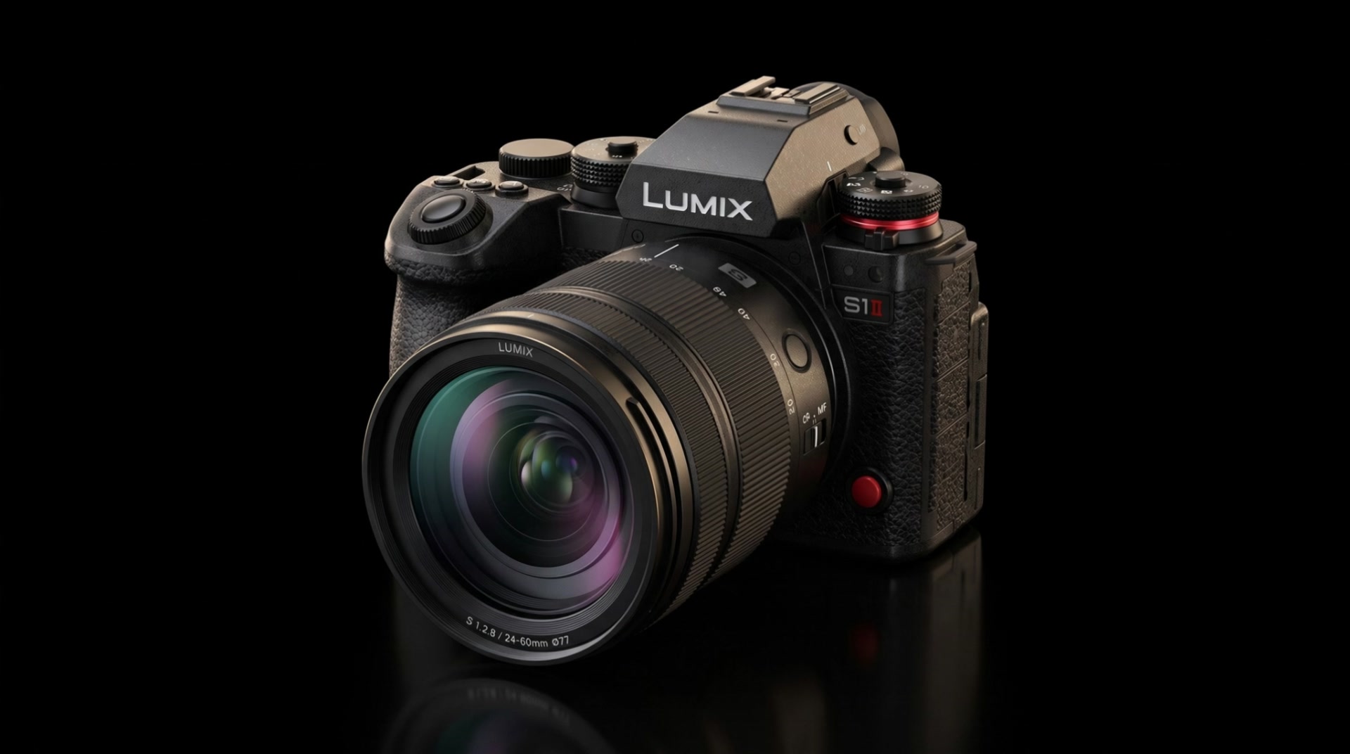 LUMIX S1 II with 24-60mm lens on a black reflective surface, lit with gold rim light