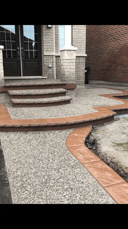 Curved exposed aggregate walkway with a warm-toned border