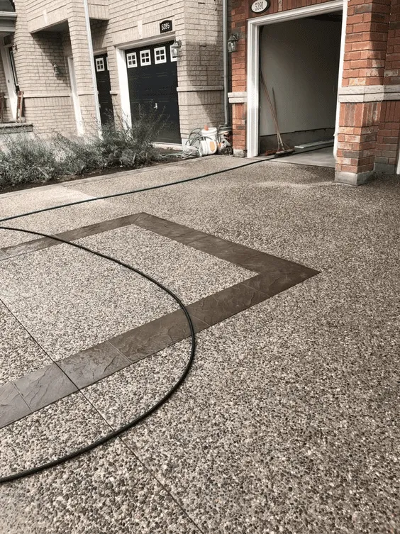 Exposed aggregate walkway with curved dark accent borders