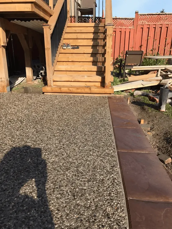 Exposed aggregate backyard steps and patio landing