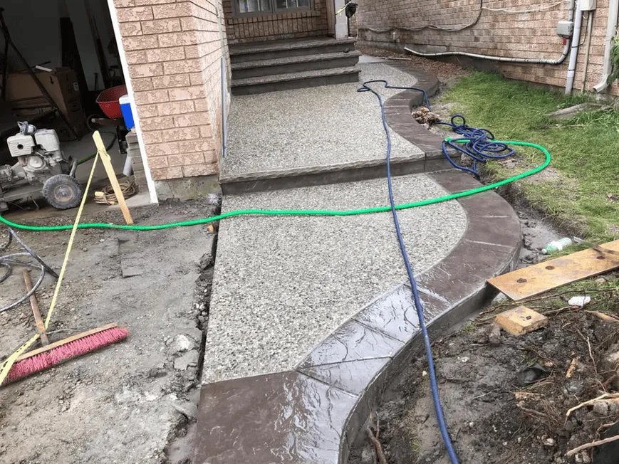 New exposed aggregate surface during finishing work