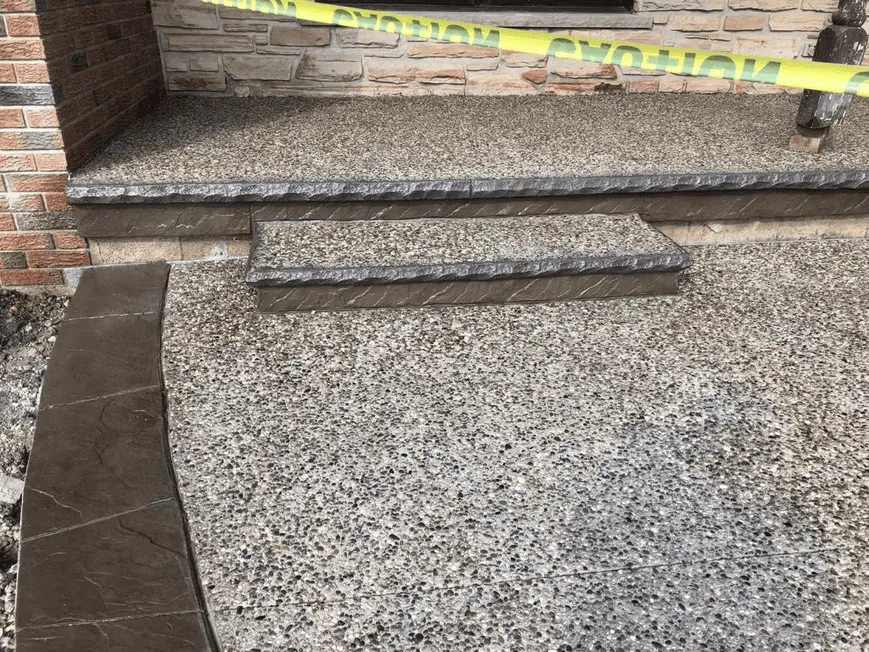 Exposed aggregate concrete steps and landing at a front entrance