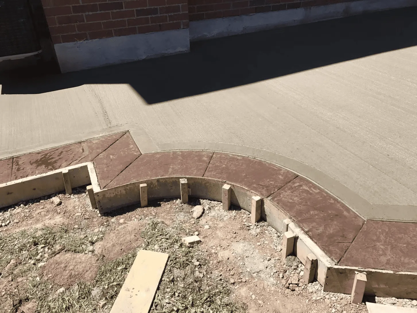 Plain concrete patio and walkway with a decorative border