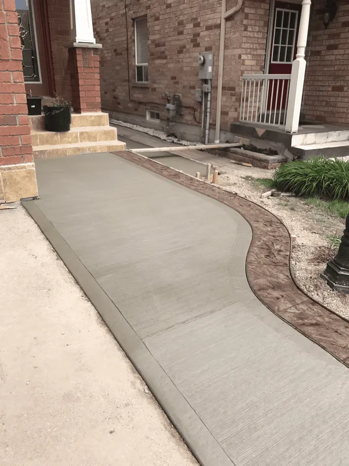 Plain concrete side walkway beside a home