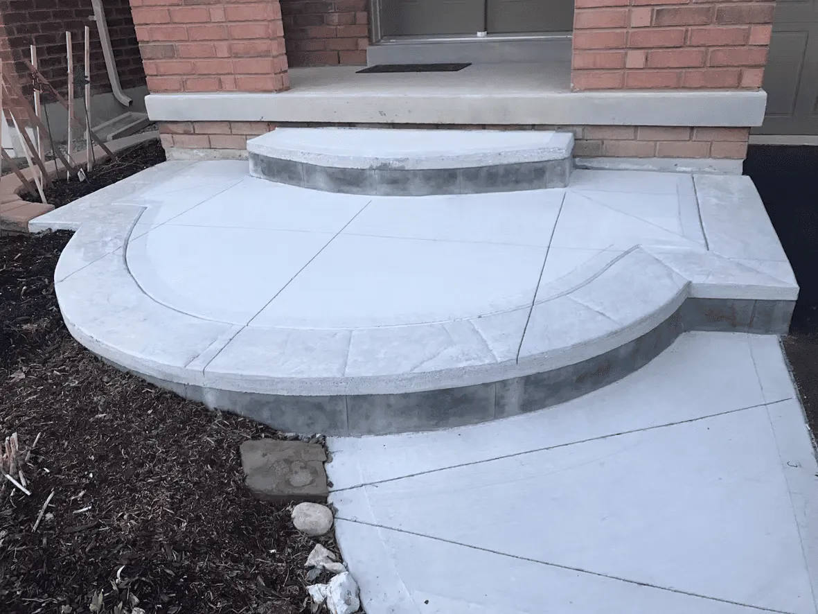 Rounded plain concrete front landing and steps