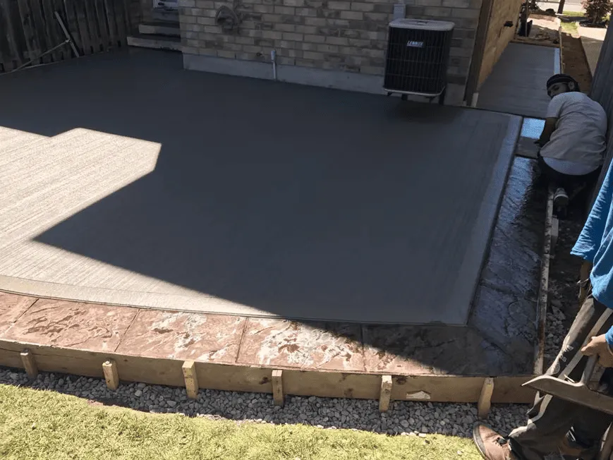 Plain concrete backyard pad during installation