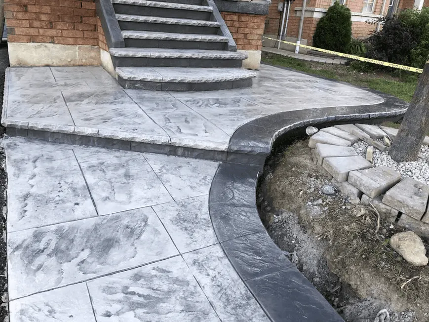 Stamped concrete landing with a textured rectangular pattern
