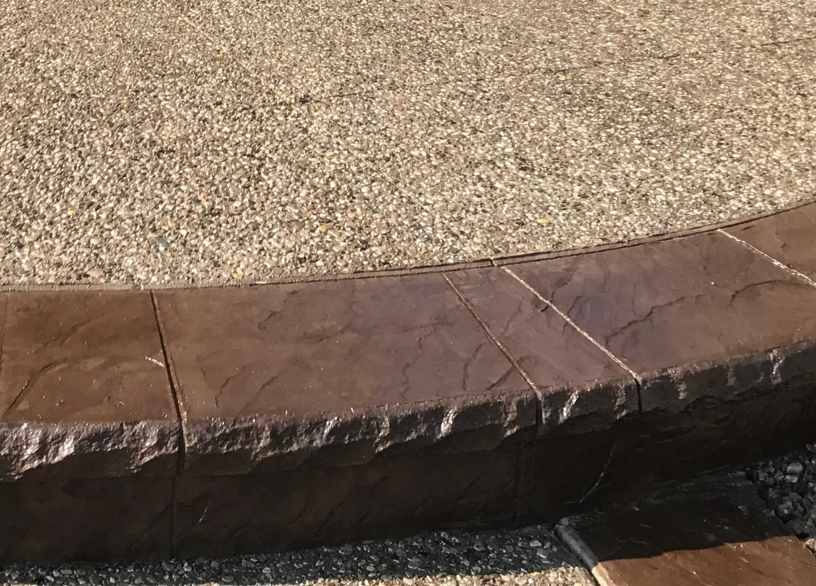 Detail of an exposed aggregate concrete edge and border