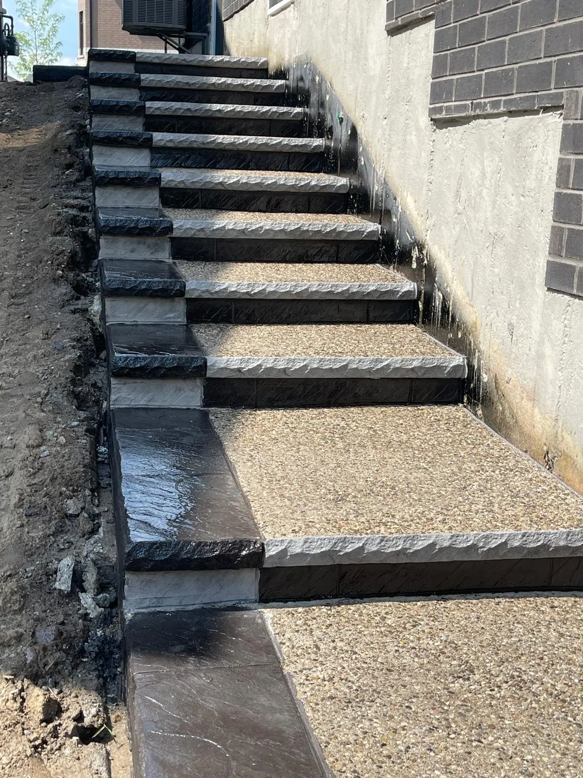 Long exposed aggregate side steps with dark edge borders