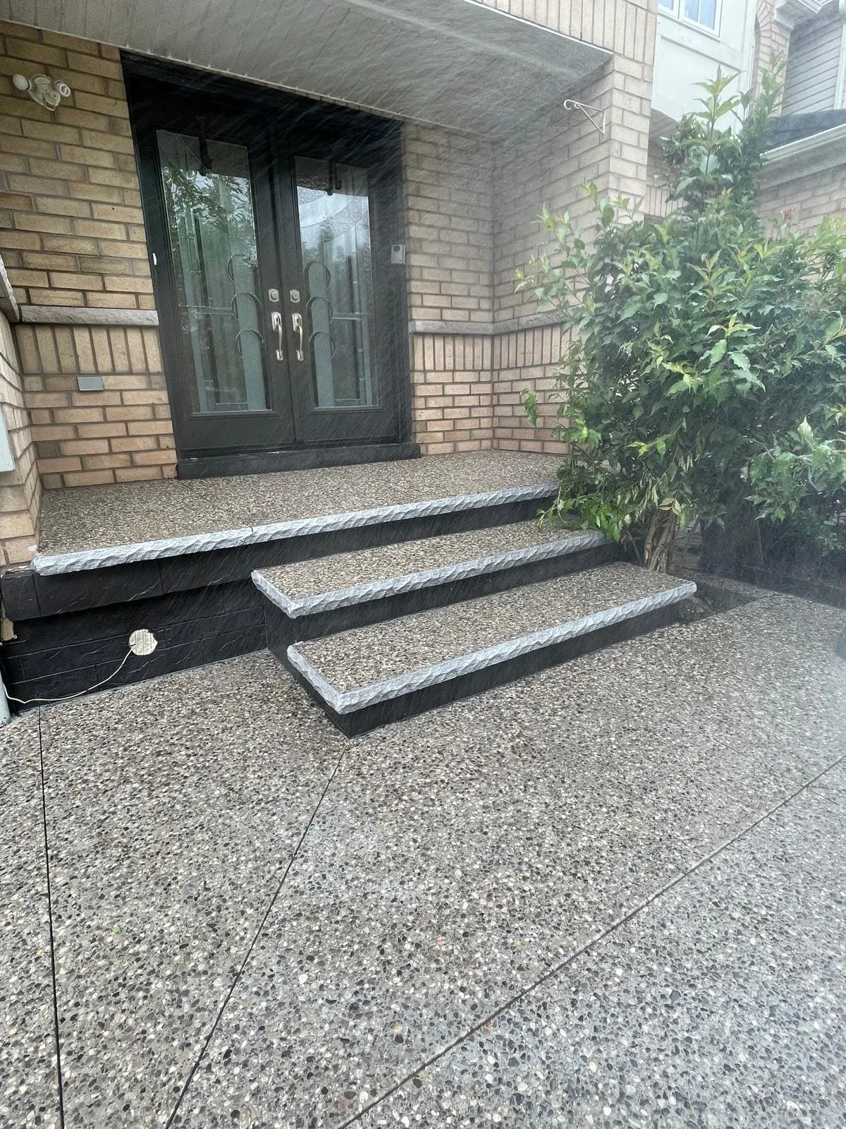 Finished exposed aggregate front entrance with decorative borders