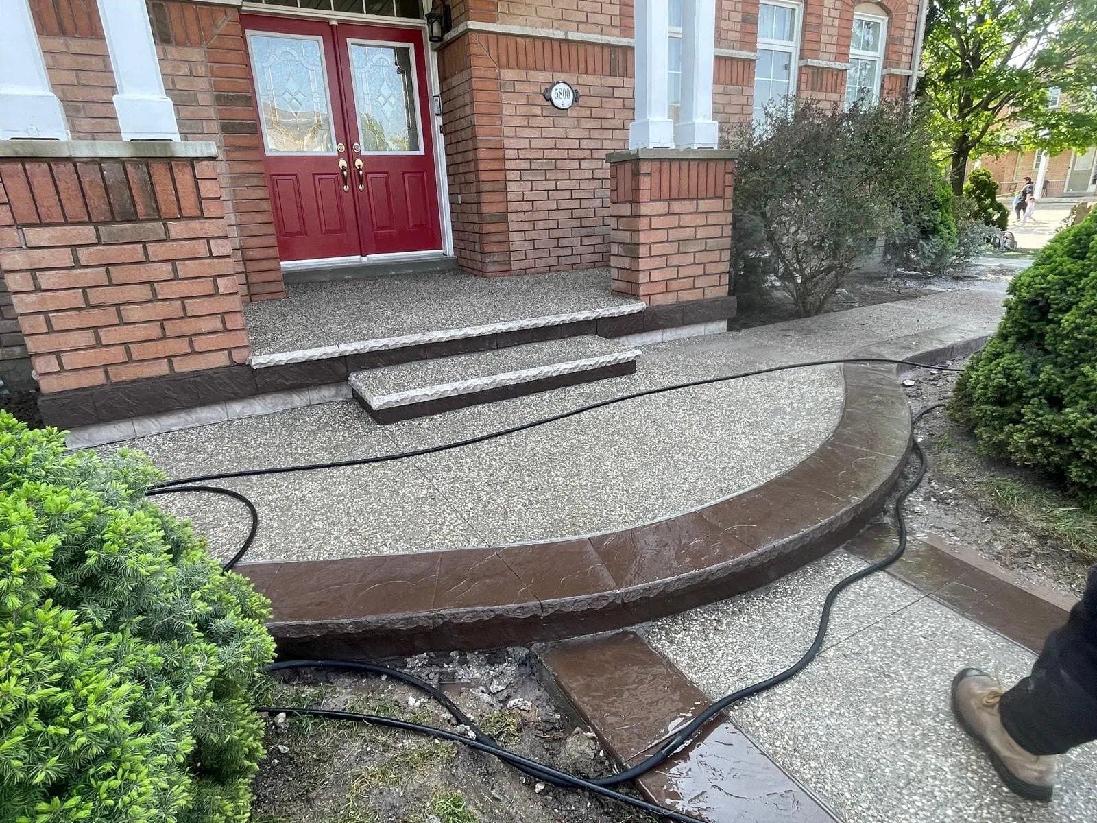 Finished exposed aggregate porch and curved front walkway