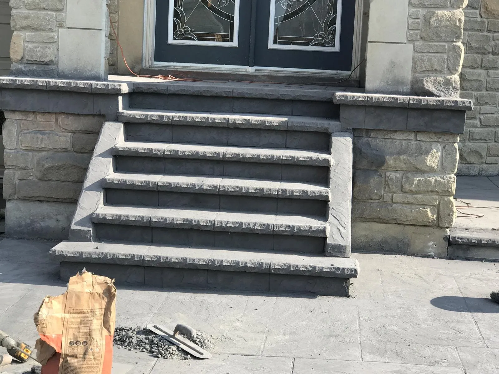 Finished stamped concrete front steps with dark borders