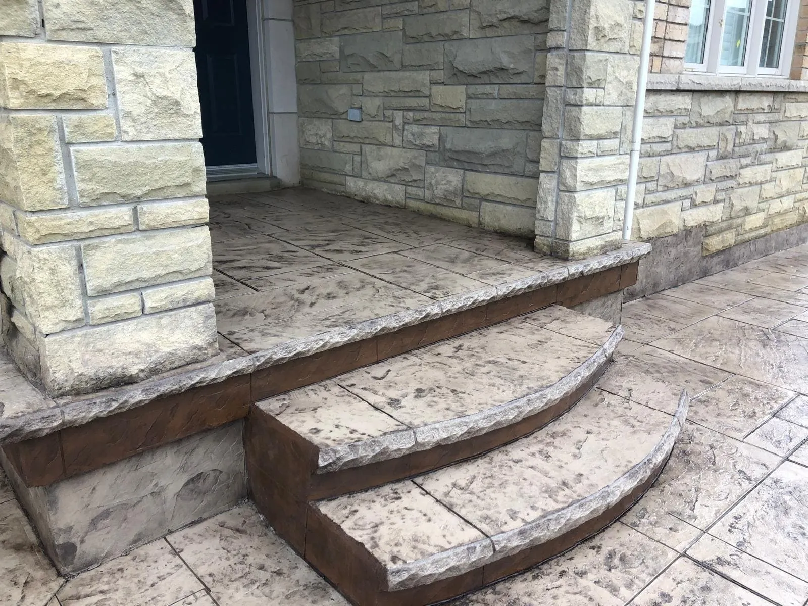 Curved stamped concrete steps and entrance landing