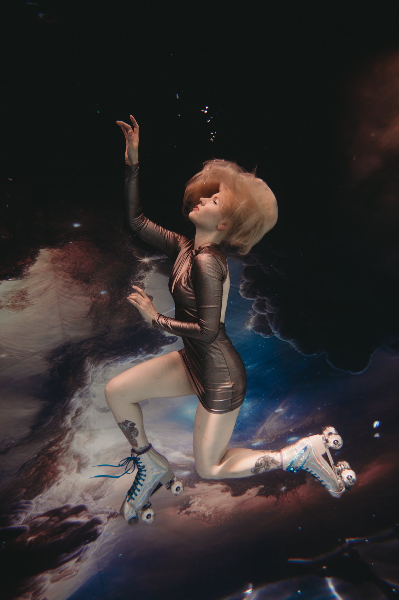 A woman in a metallic dress and roller skates floating against a starry backdrop