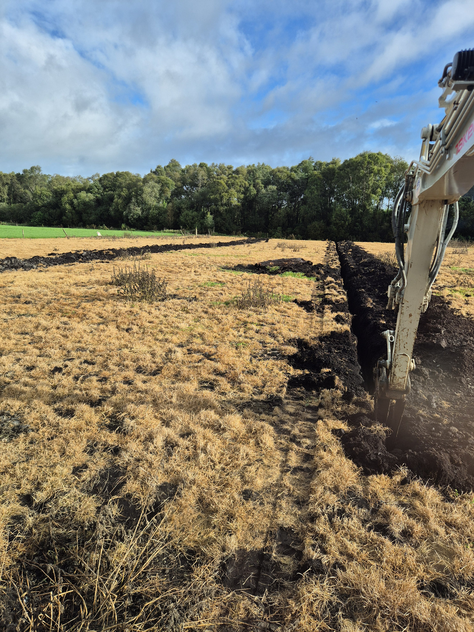 Land drainage excavation across a field
