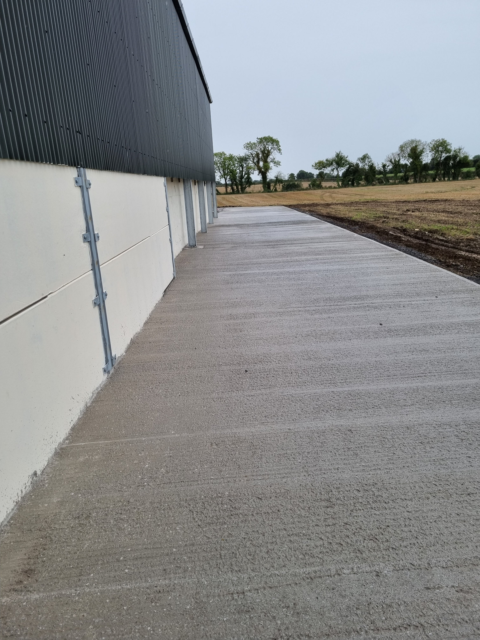 Concrete yard beside a farm building