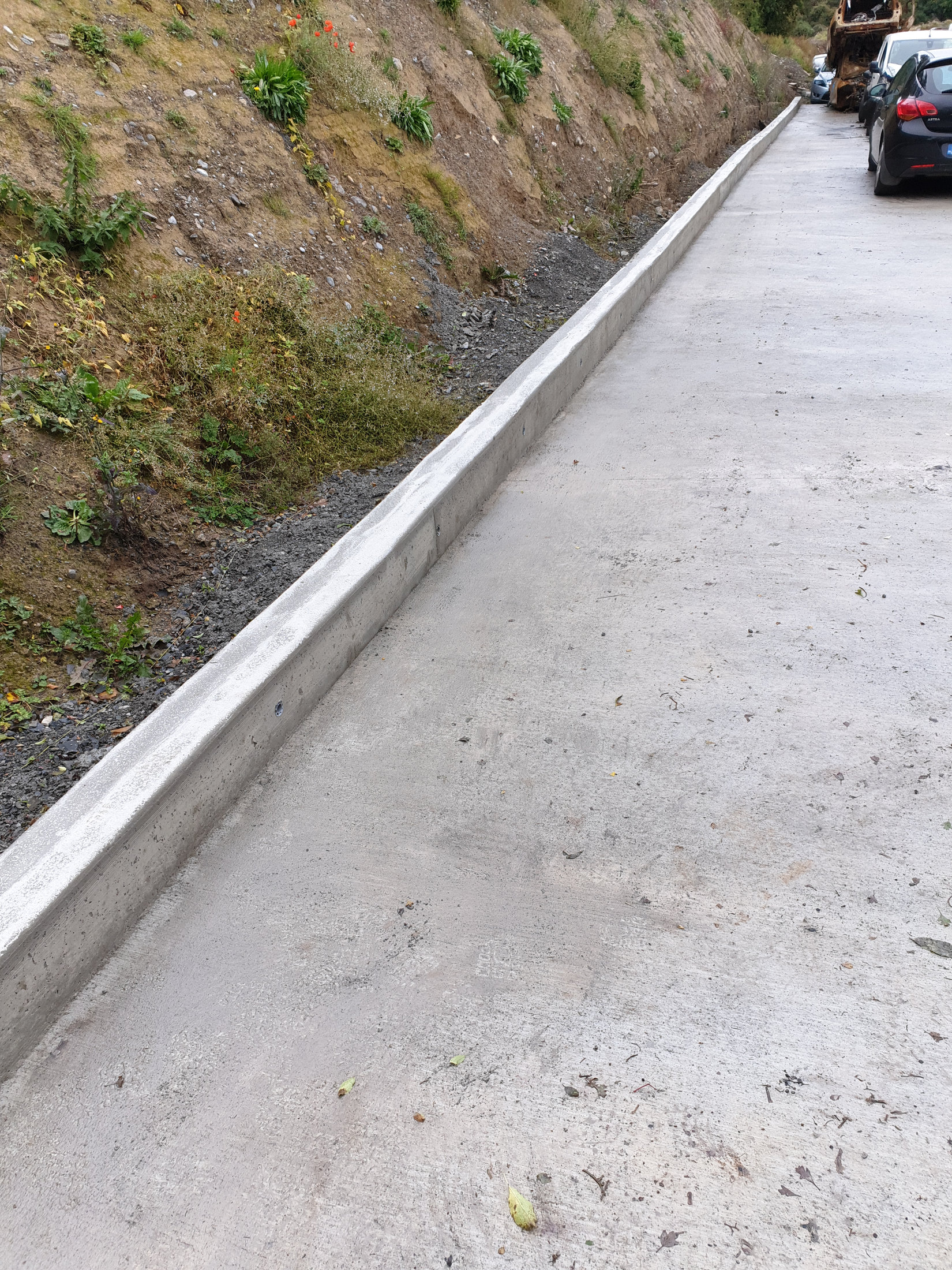 Concrete kerbing alongside a paved surface