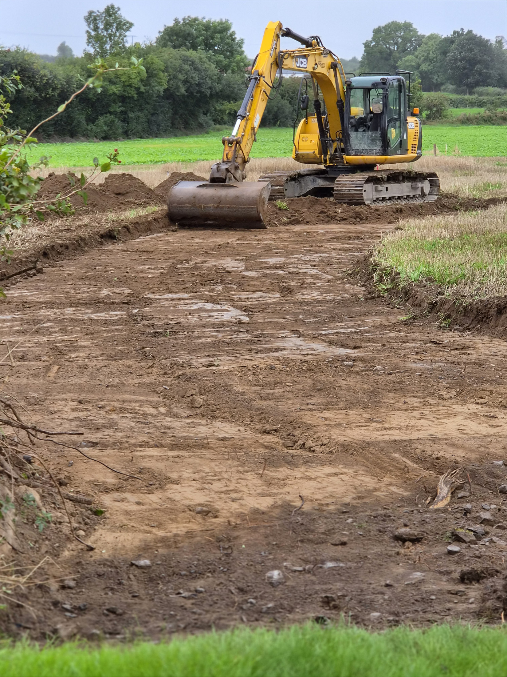 Excavator preparing a groundworks site
