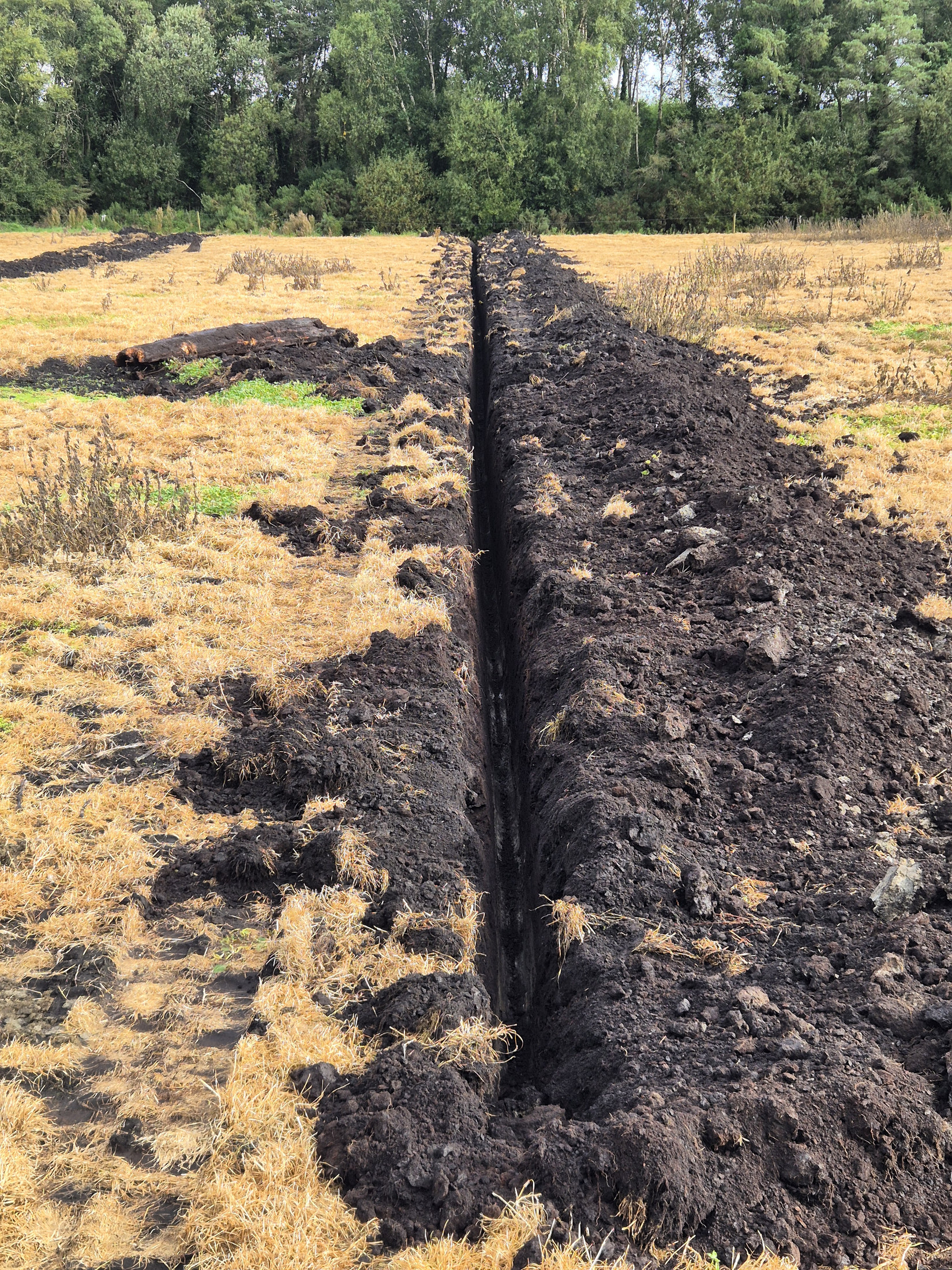 Land drainage trench across a field