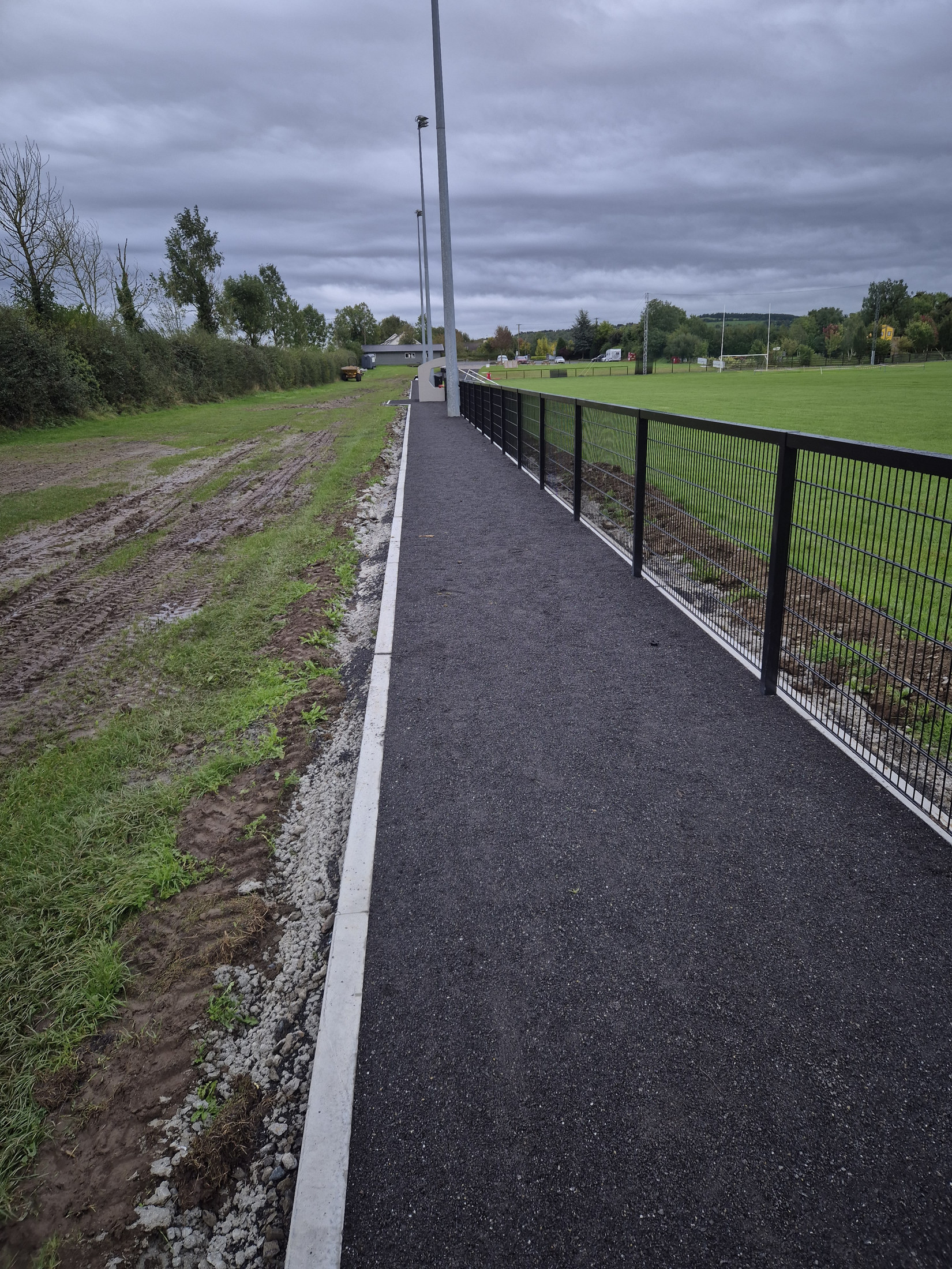 Finished asphalt path alongside the pitch