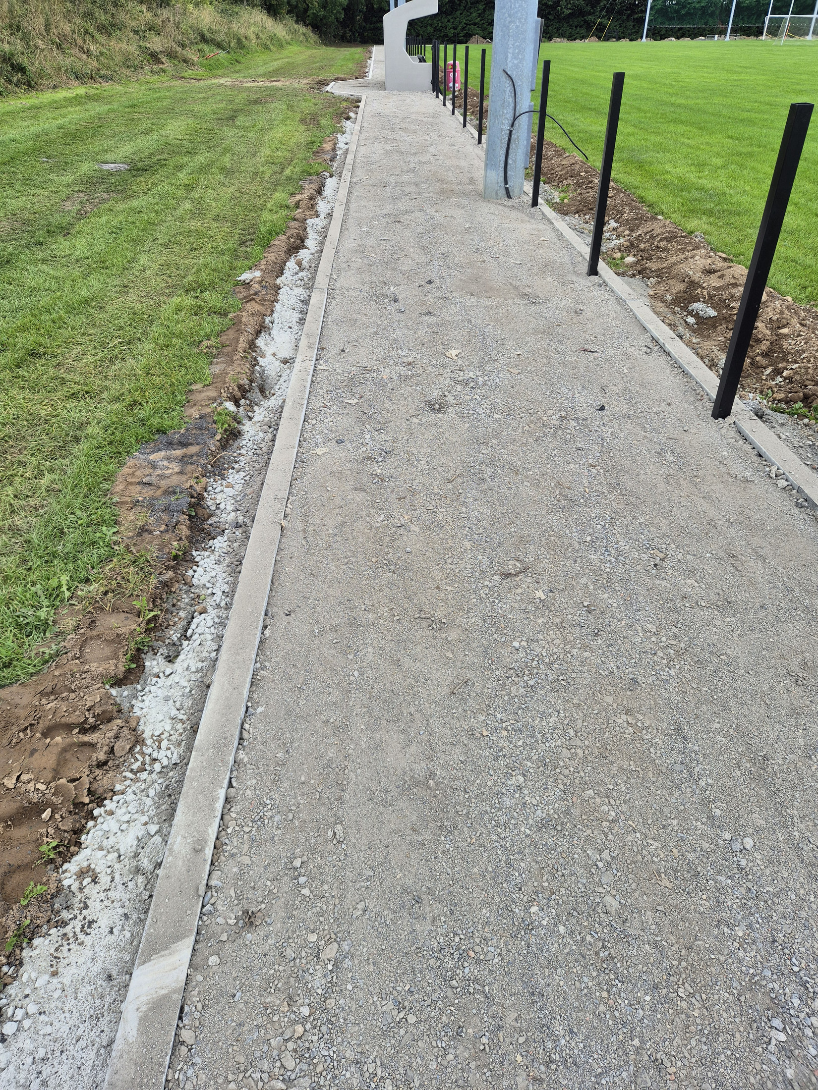 Concrete path surface between kerbs