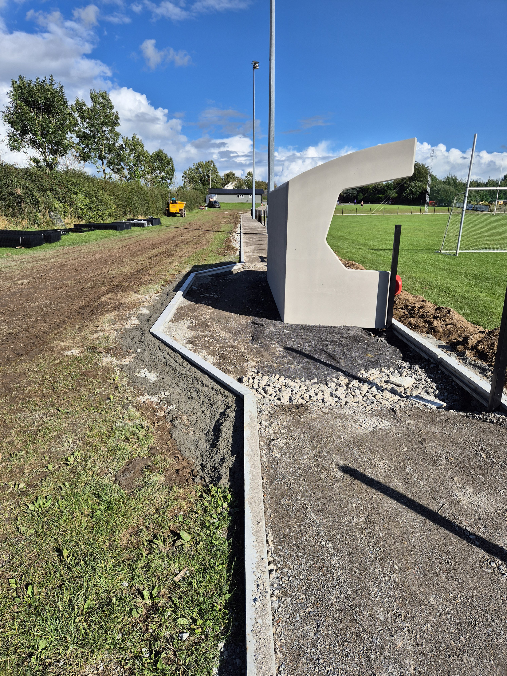 Scoreboard beside the kerbed path
