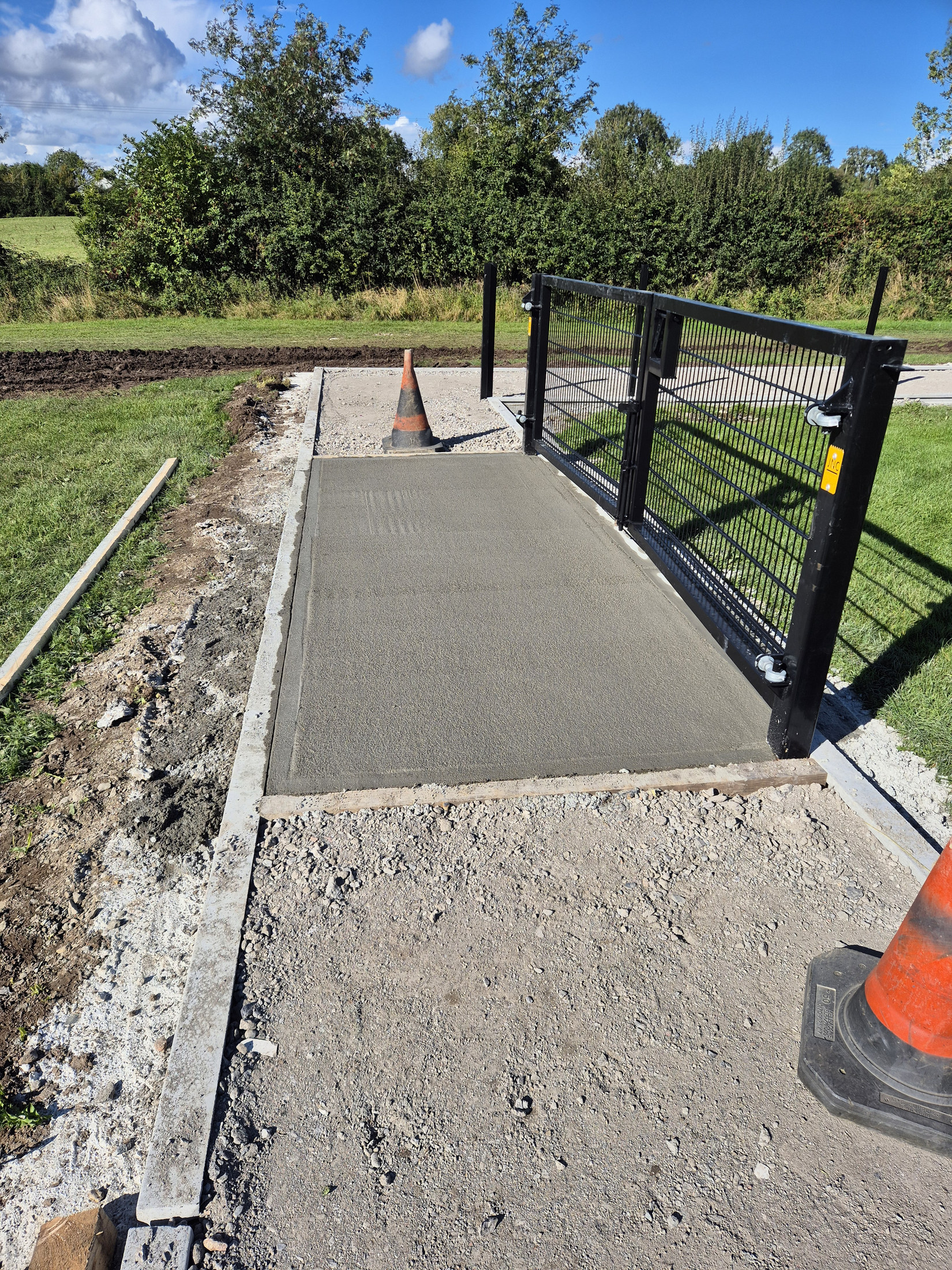 New concrete path section beside the gate