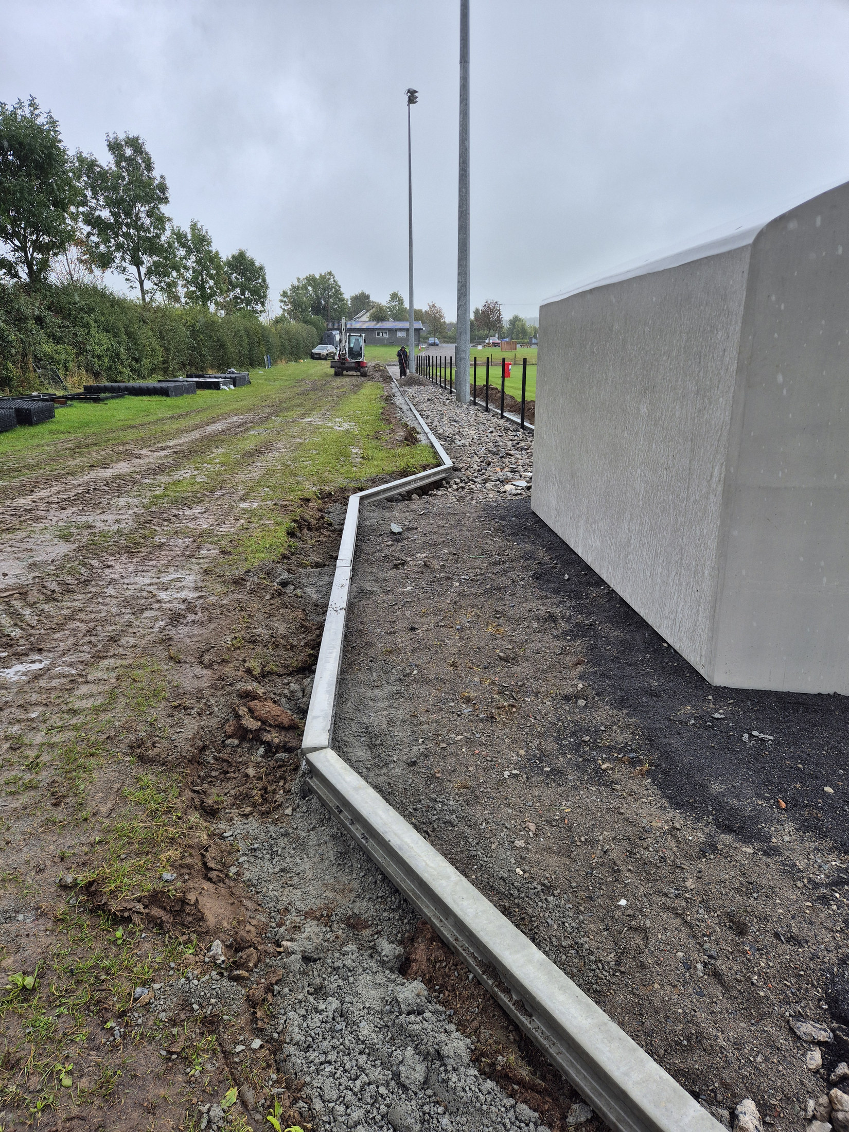 Kerbing and path base beside the building