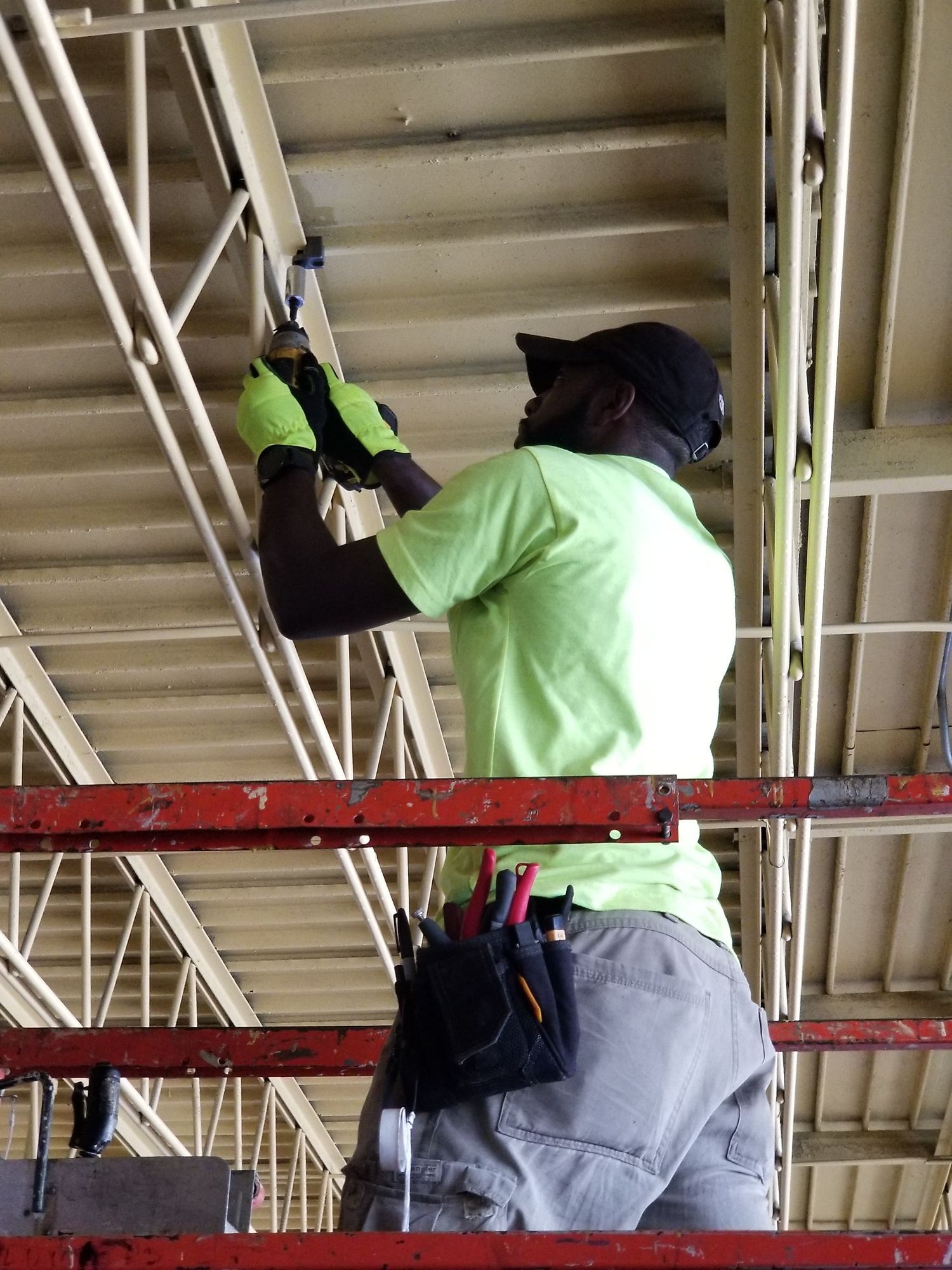 Technician installing commercial overhead ductwork