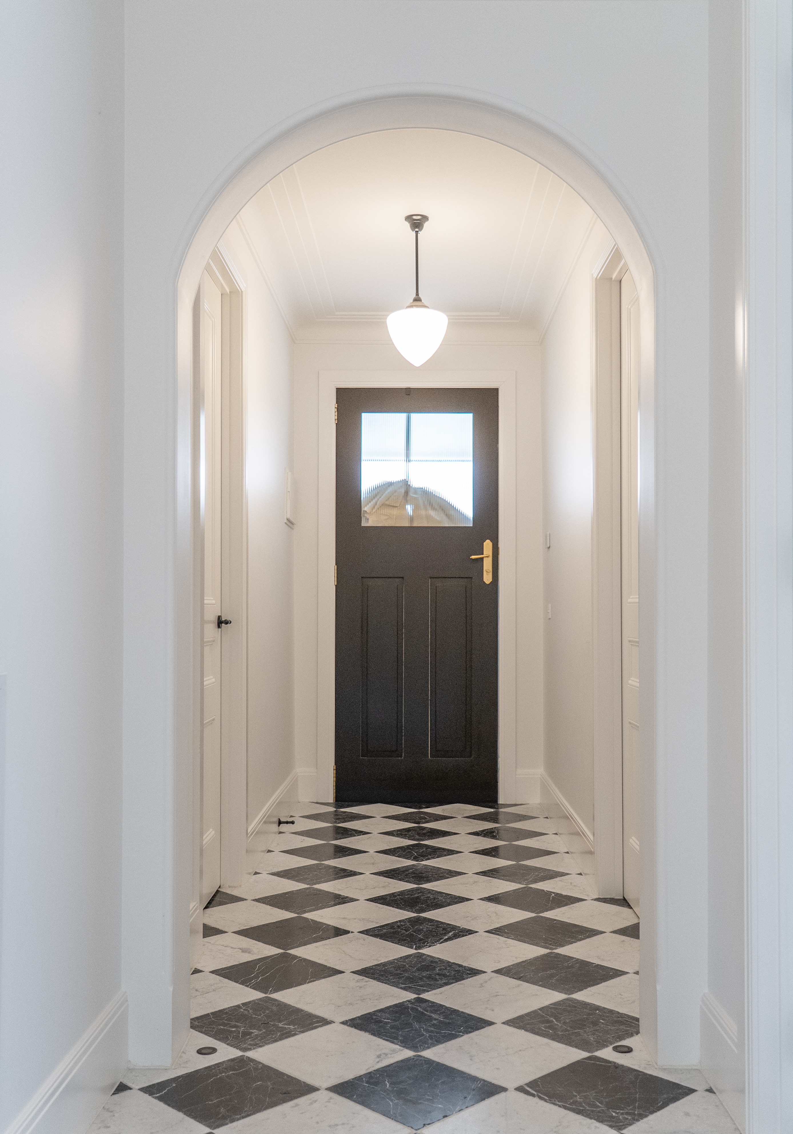 Home renovation Melbourne arched hallway with tiled floor design