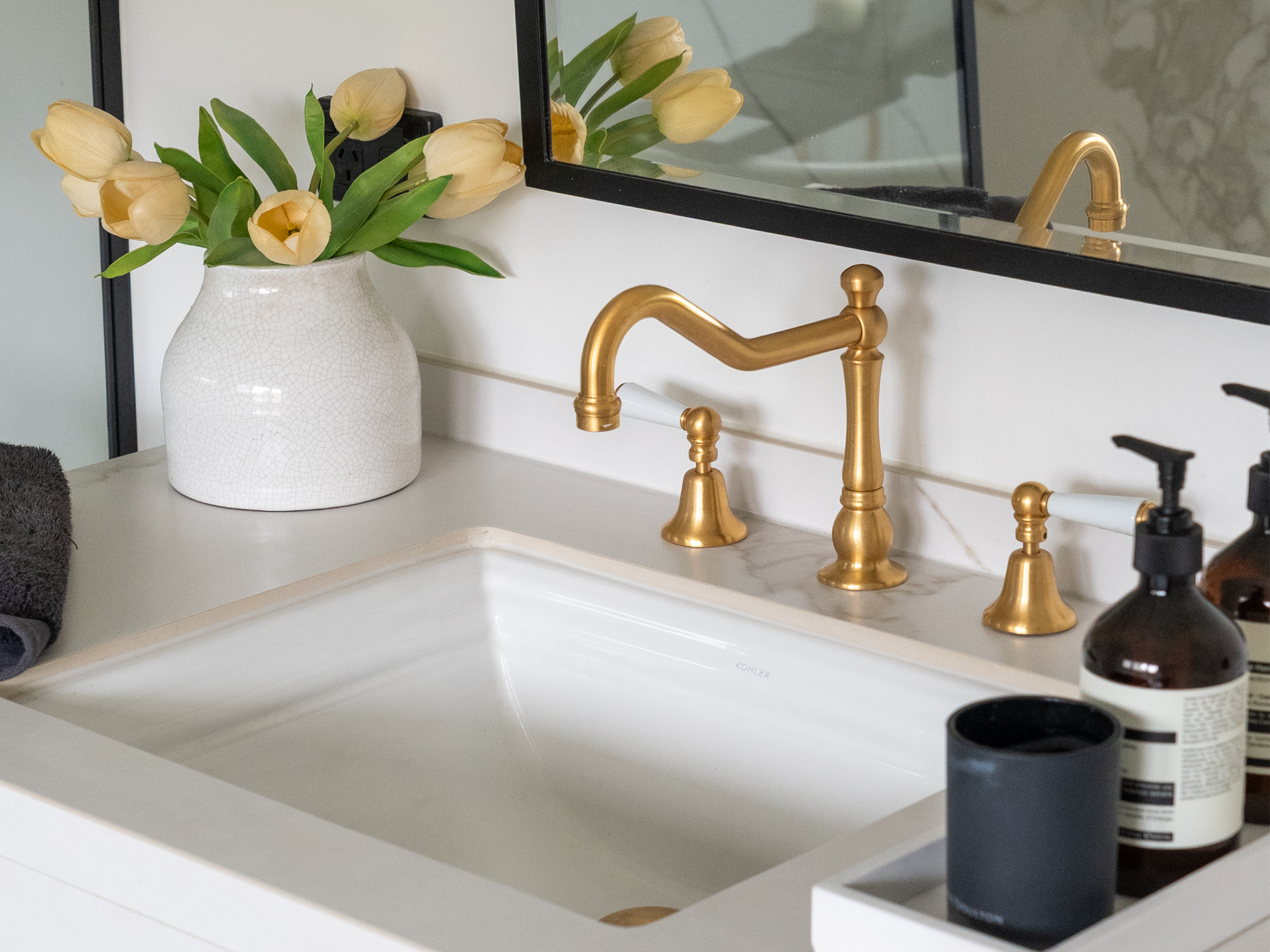 Bathroom renovation Melbourne vanity with brass tapware, sink detail, and modern styling