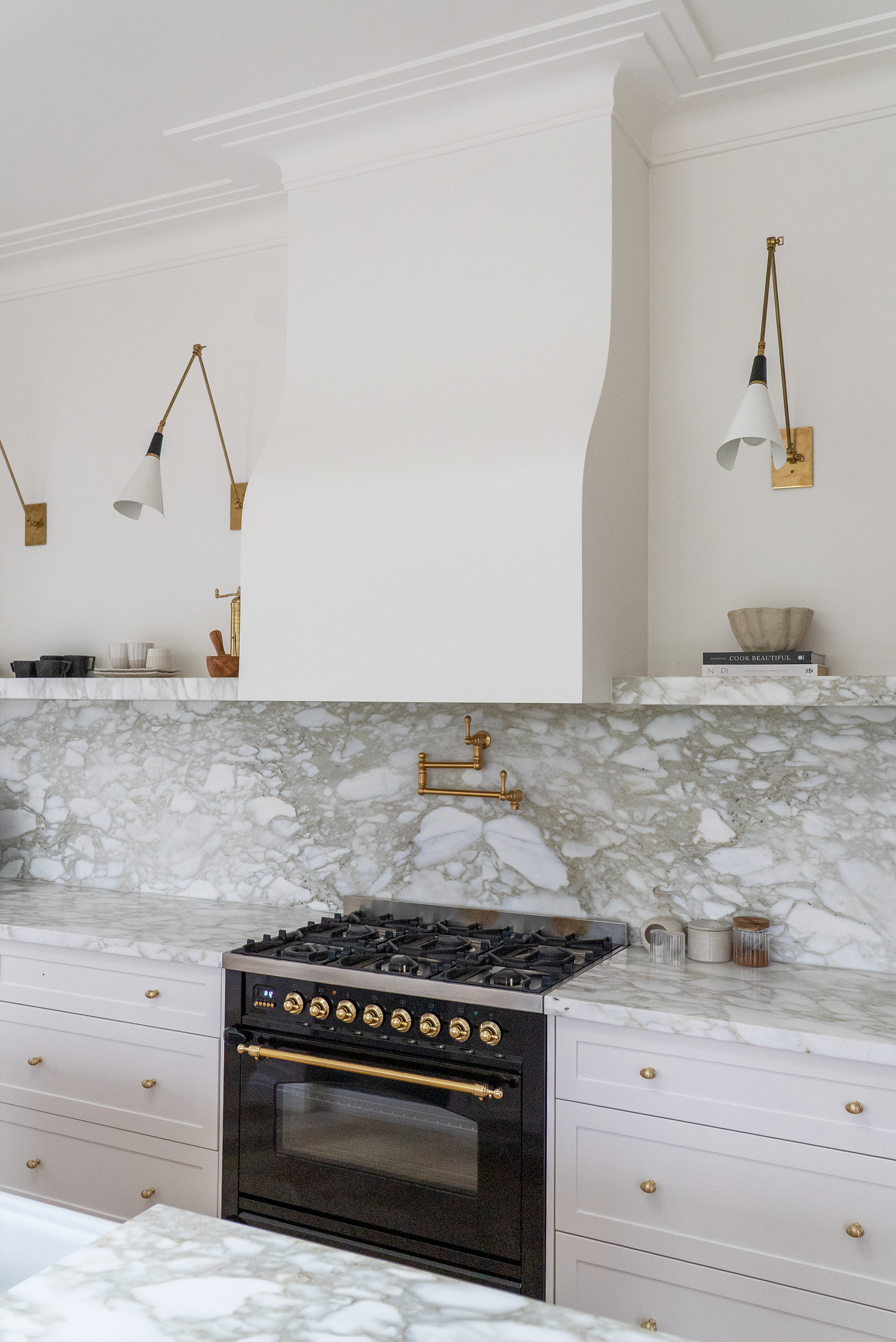 Kitchen renovation Melbourne with range cooker, marble splashback, and brass pot filler detail