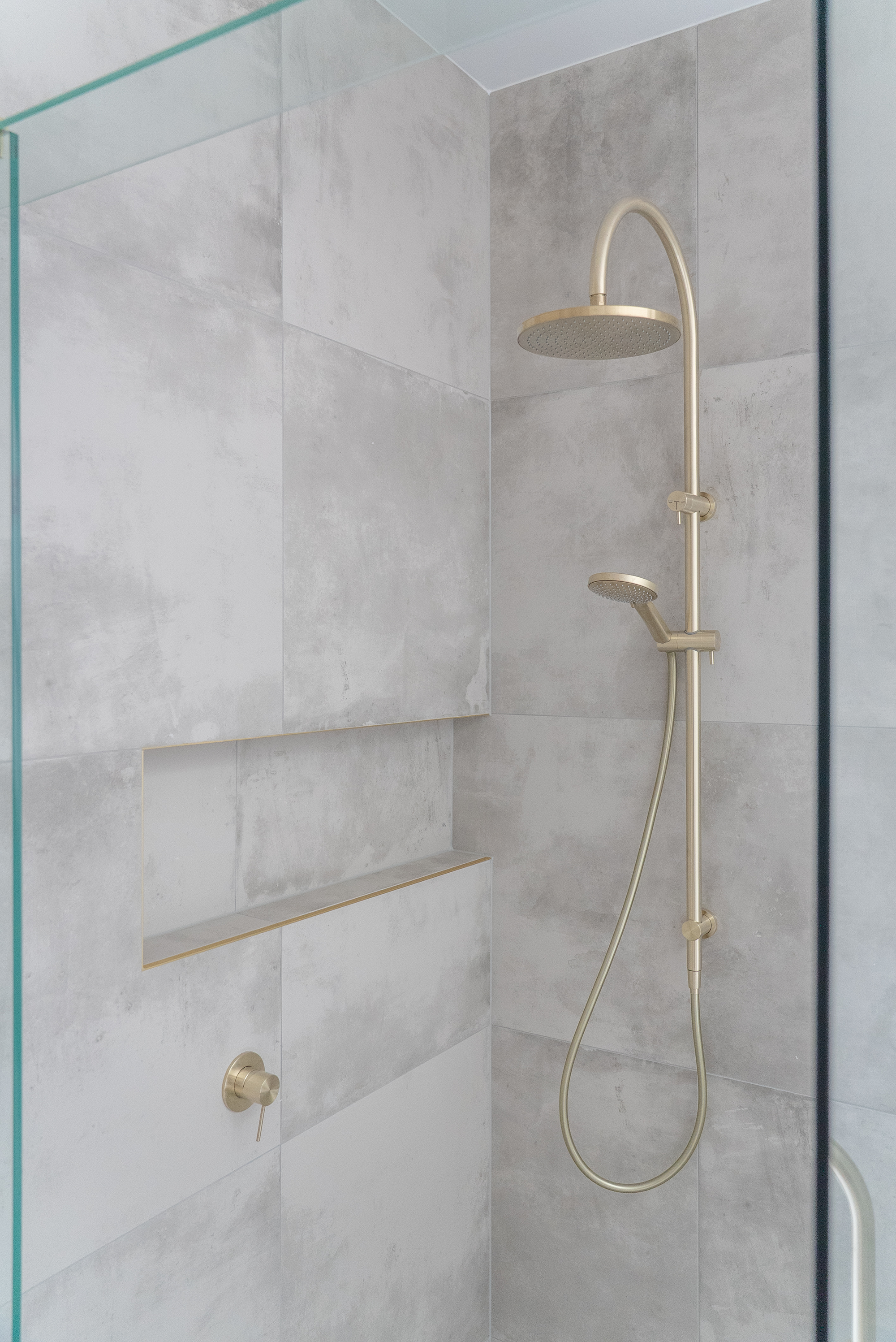 Bathroom renovation Melbourne walk-in shower with brass fixtures
