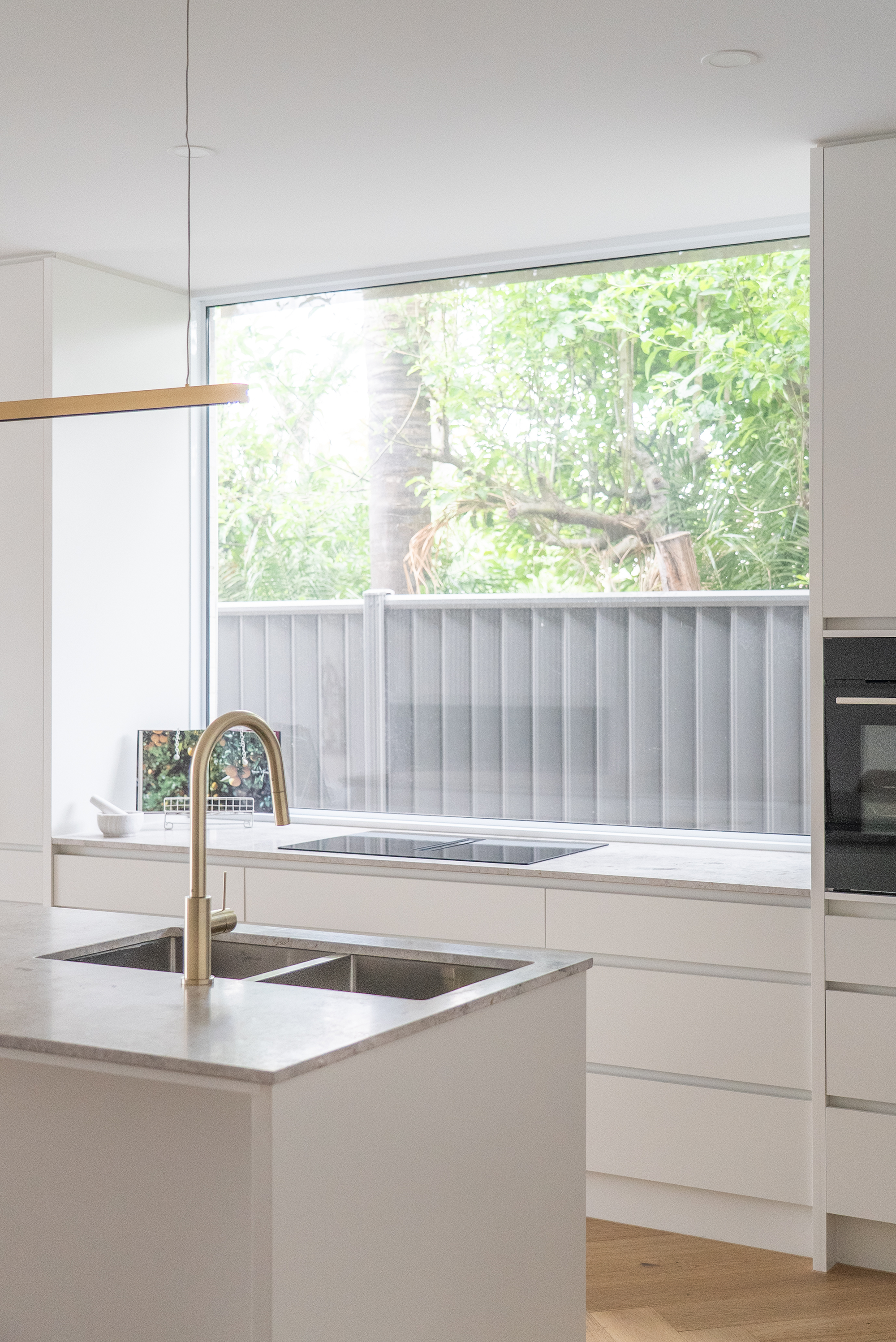Kitchen renovation Melbourne with large window, island sink, and natural light design