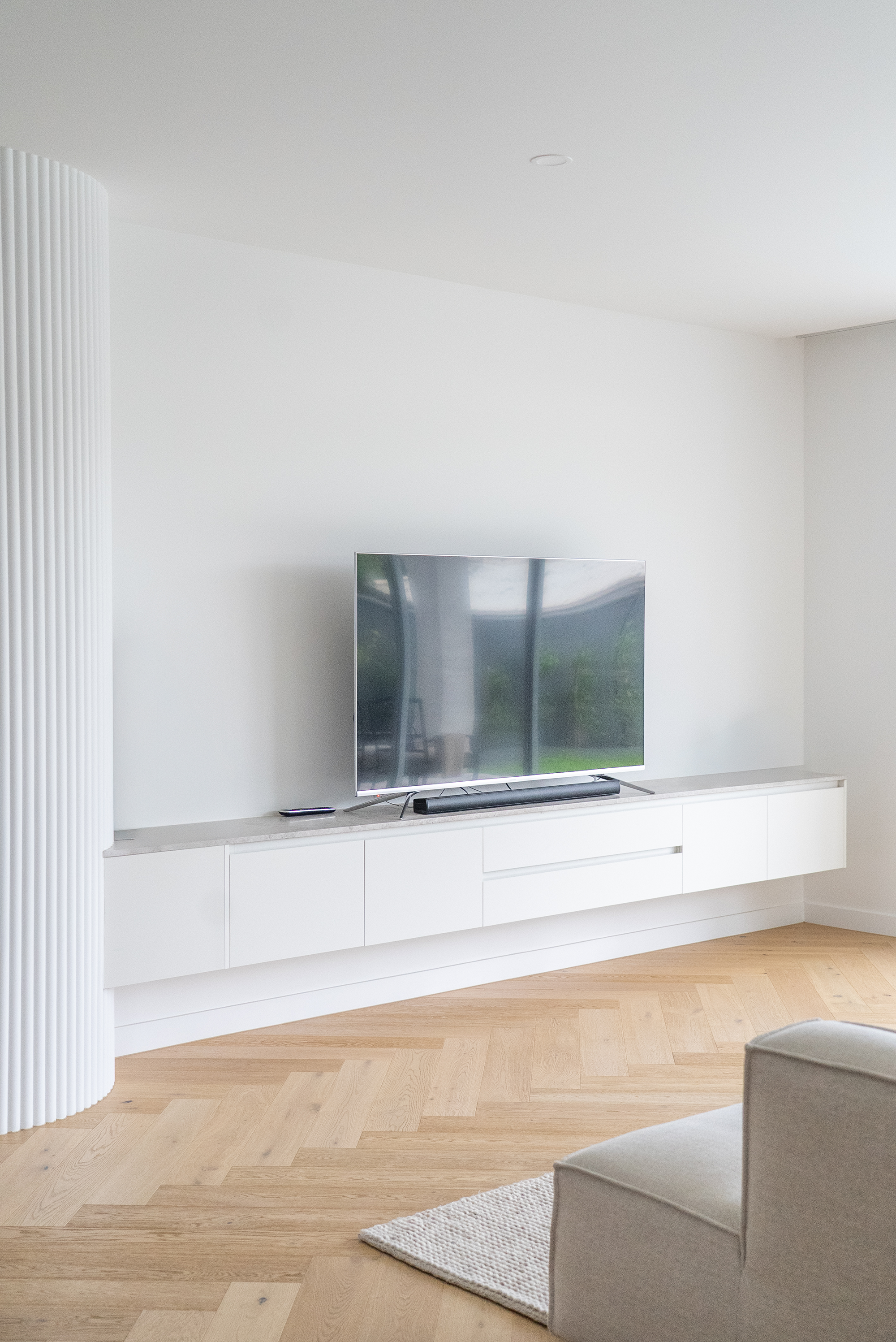 Living room renovation Melbourne with built-in TV unit and clean design