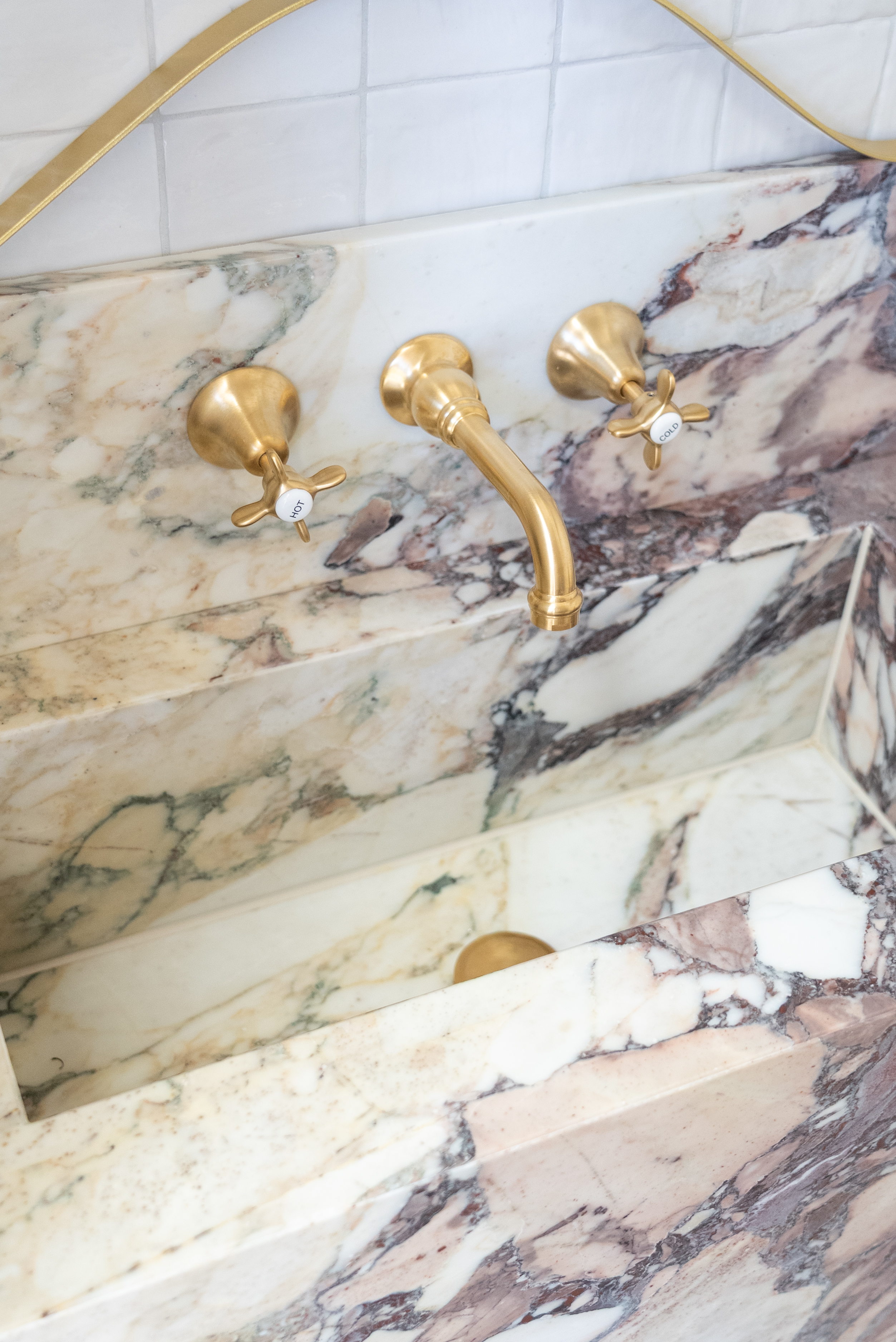 Bathroom renovation Melbourne marble wall and brass tapware detail