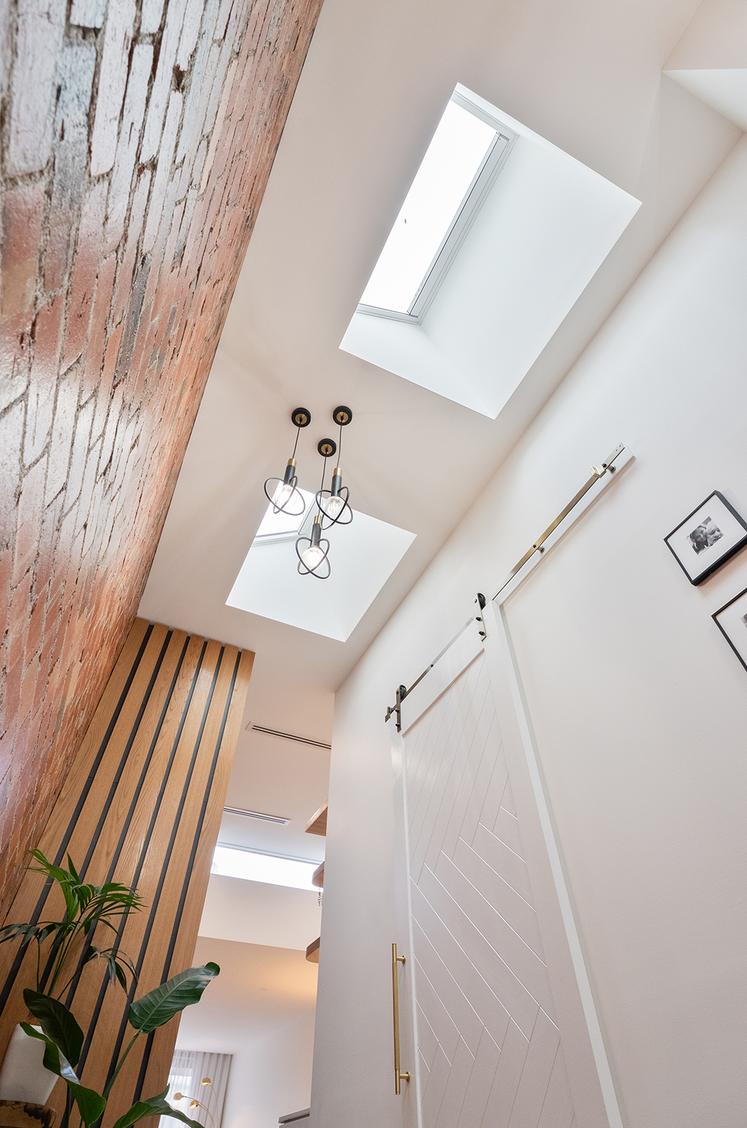 Port Melbourne home entry with skylights and feature brick wall.