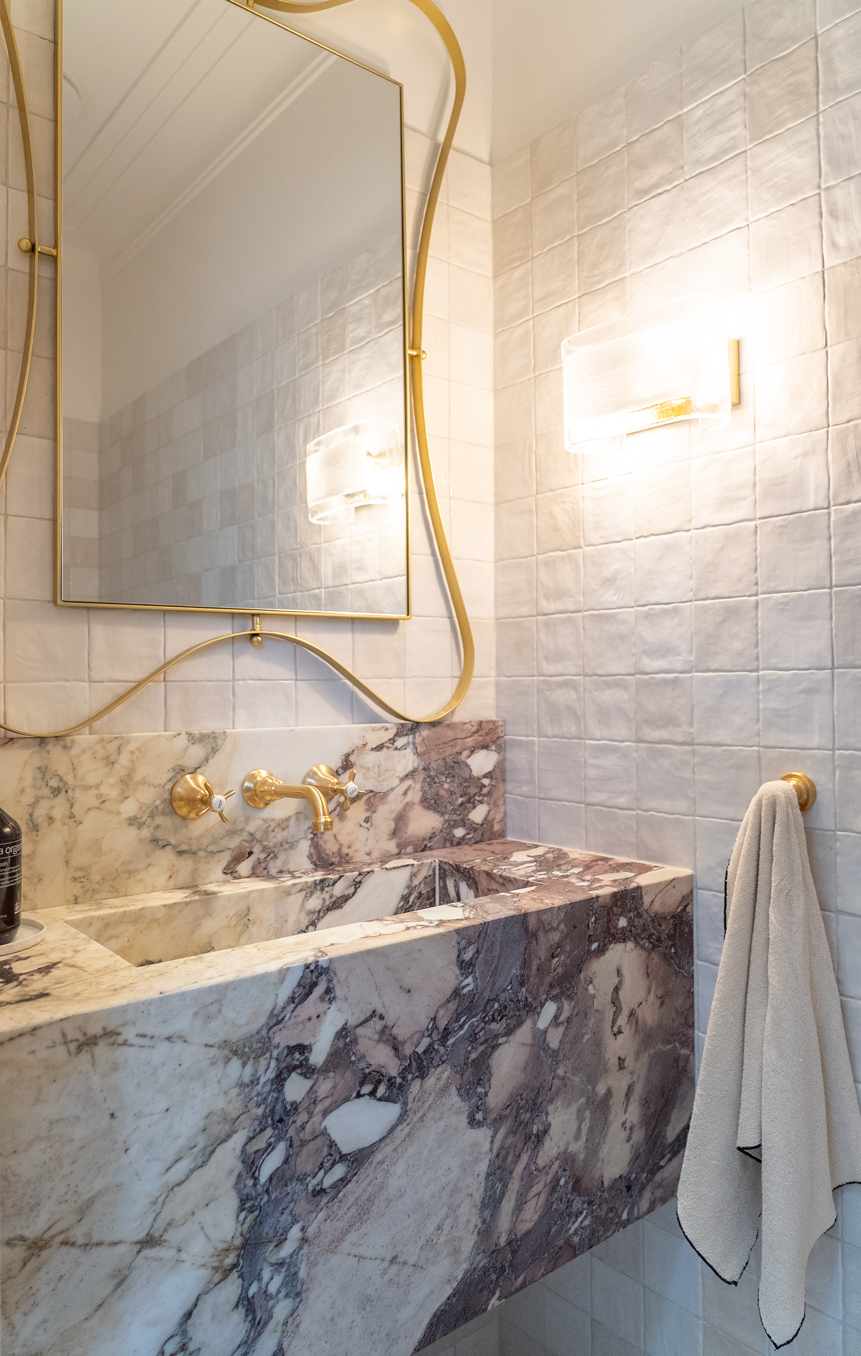 Bathroom renovation Melbourne vanity with mirror, marble benchtop, brass tapware, and walk-in shower