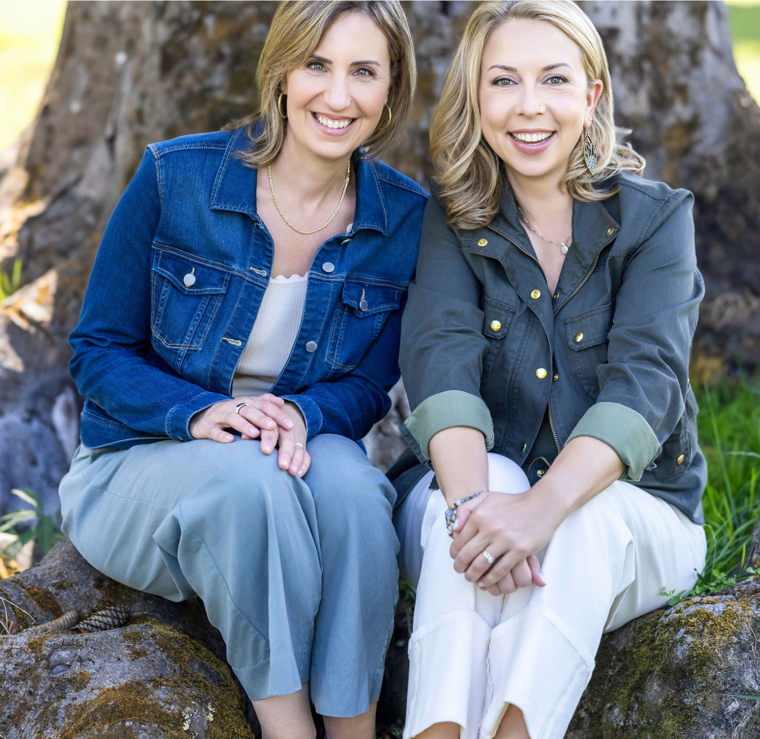Two women sitting outdoors smiling together, representing supportive gut health coaching and wellness guidance for women navigating perimenopause and menopause.