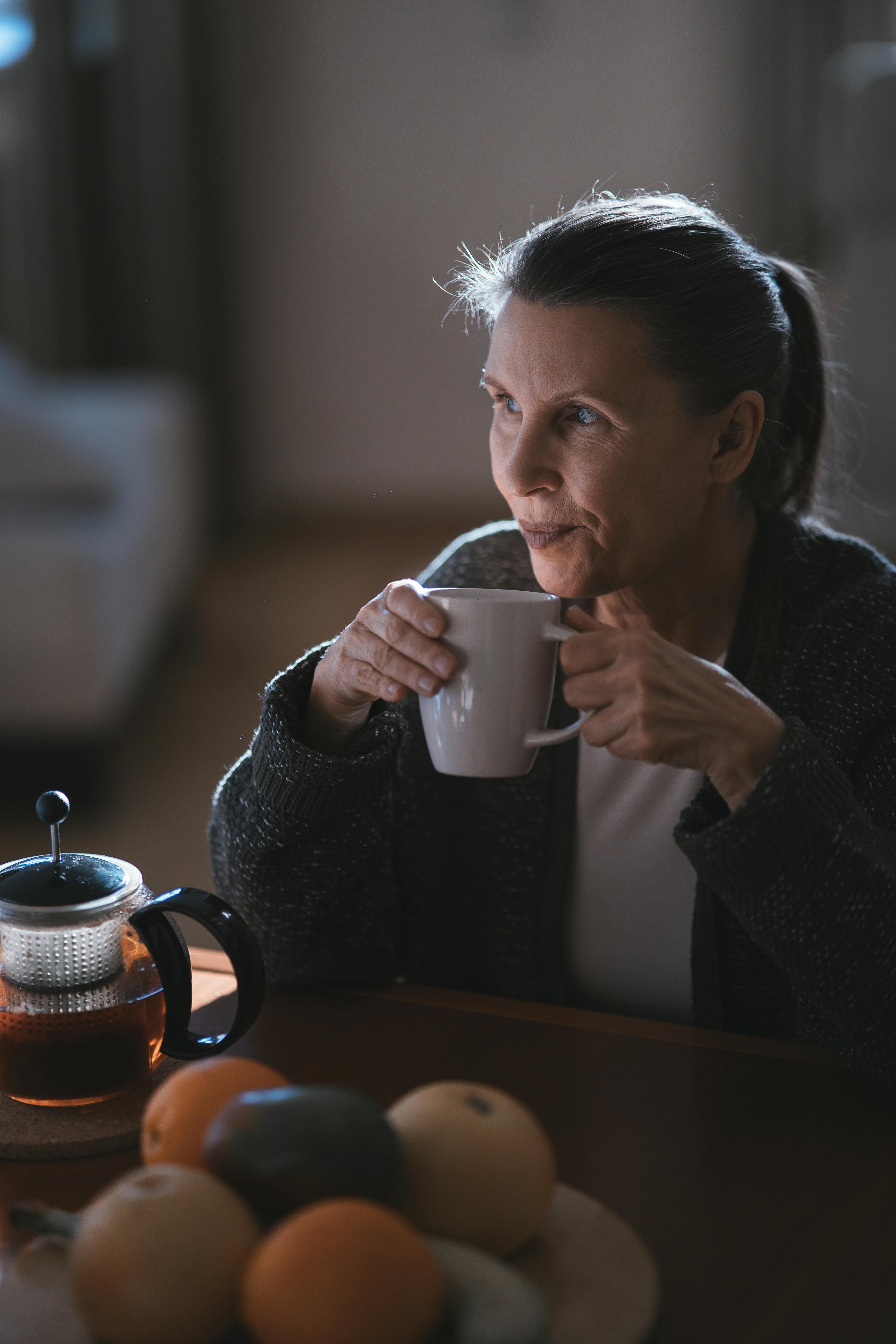 midlife woman drinking tea calm morning routine perimenopause wellness