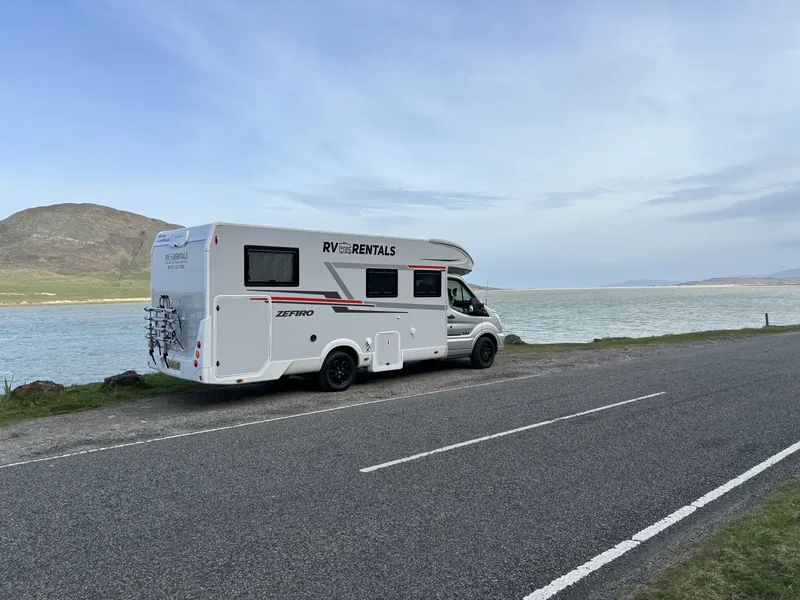 RV Rentals motorhome beside Highland water and hills