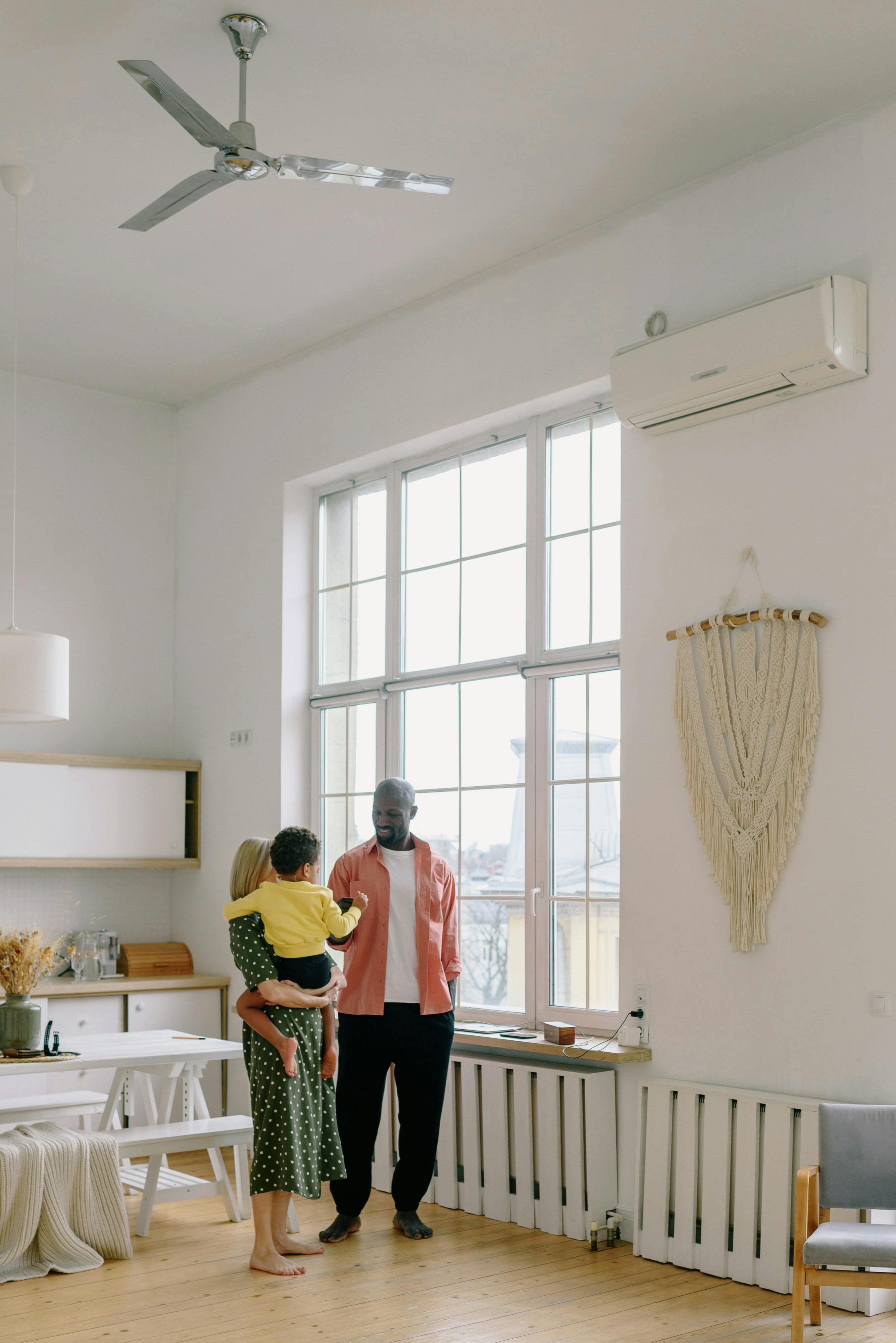 Happy family at home with ductless mini-split air conditioning โ Flex Mechanical HVAC service
