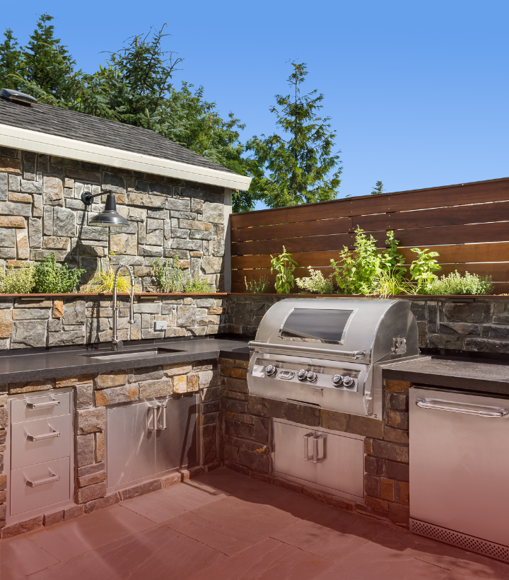 Outdoor kitchen and fire feature built with stone and brick in New Jersey