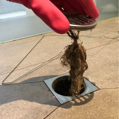 Removing hair and debris from a clogged shower drain