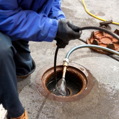 Professional drain cleaning with hydro-jetting equipment