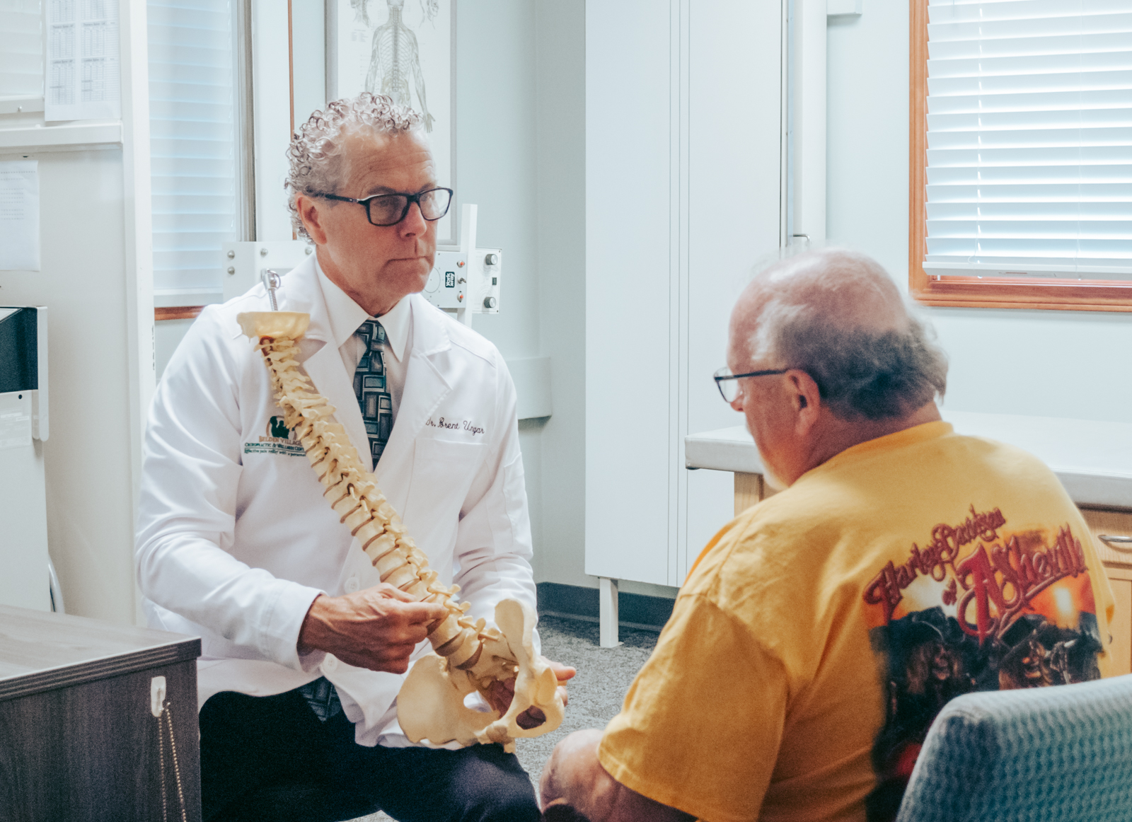 Dr. Brent Ungar consulting with a patient about spinal health